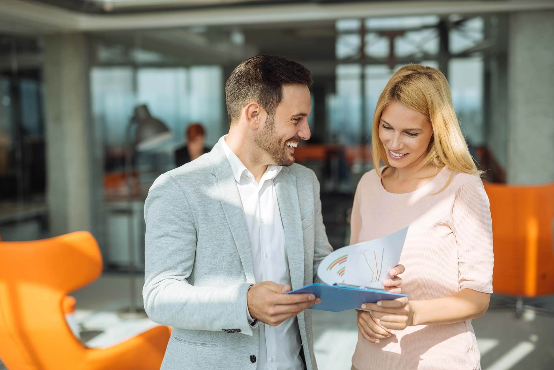 2 Employees Viewing Data Analysis and Graphs developed by Benchmarking Software